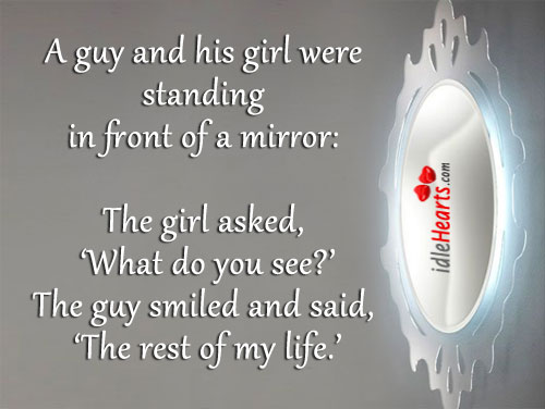 A guy and his girl were standing in front of a mirror: Image
