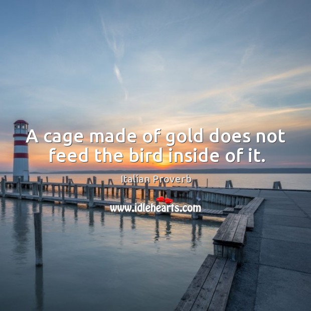 A cage made of gold does not feed the bird inside of it. Image