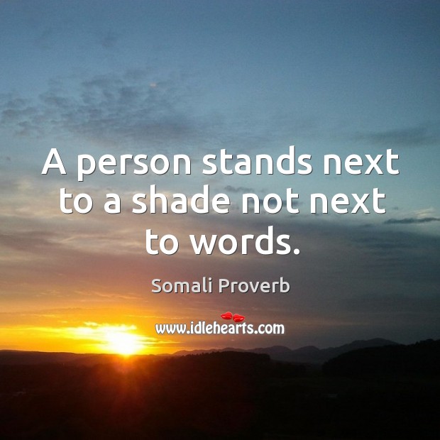 A person stands next to a shade not next to words. Somali Proverbs Image