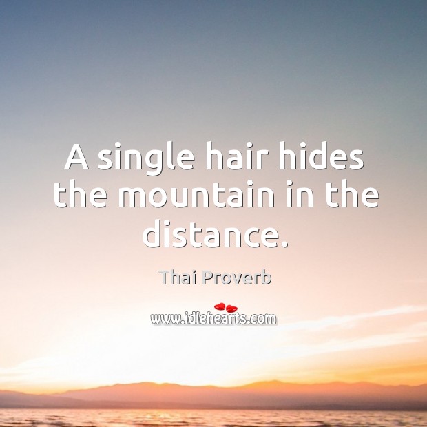 A single hair hides the mountain in the distance. Thai Proverbs Image