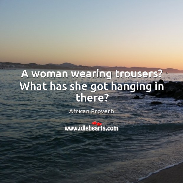 A woman wearing trousers? what has she got hanging in there? Image