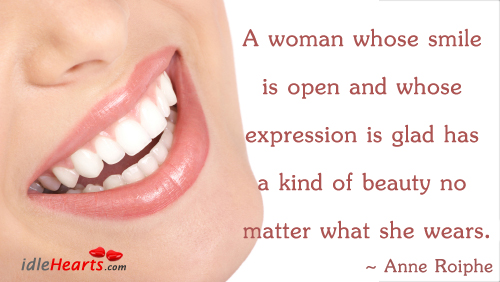 A woman whose smile is open and whose Image