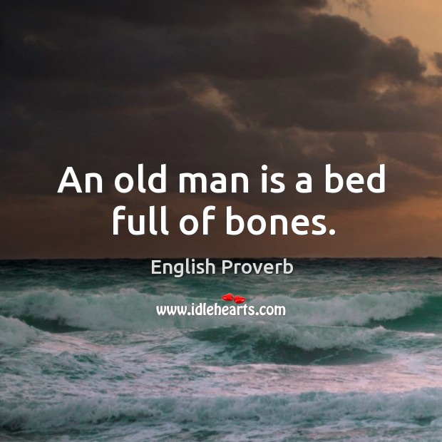 An old man is a bed full of bones. Image