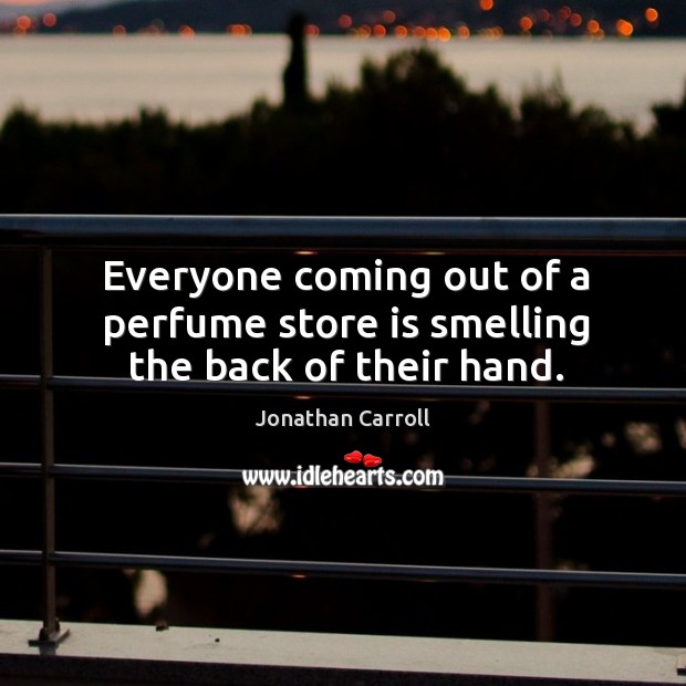 Everyone coming out of a perfume store is smelling the back of their hand. Image