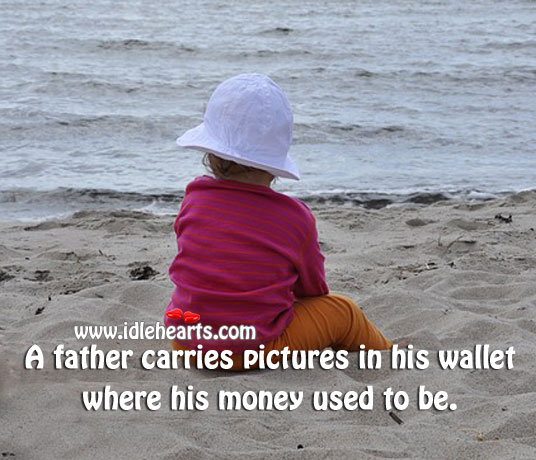 A father carries pictures in his wallet where his money used to be. Image