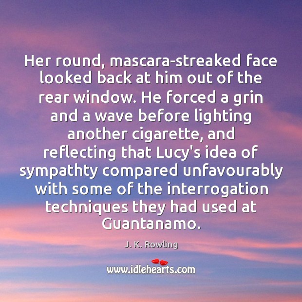 Her round, mascara-streaked face looked back at him out of the rear Image