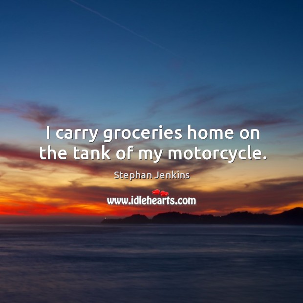 I carry groceries home on the tank of my motorcycle. Image
