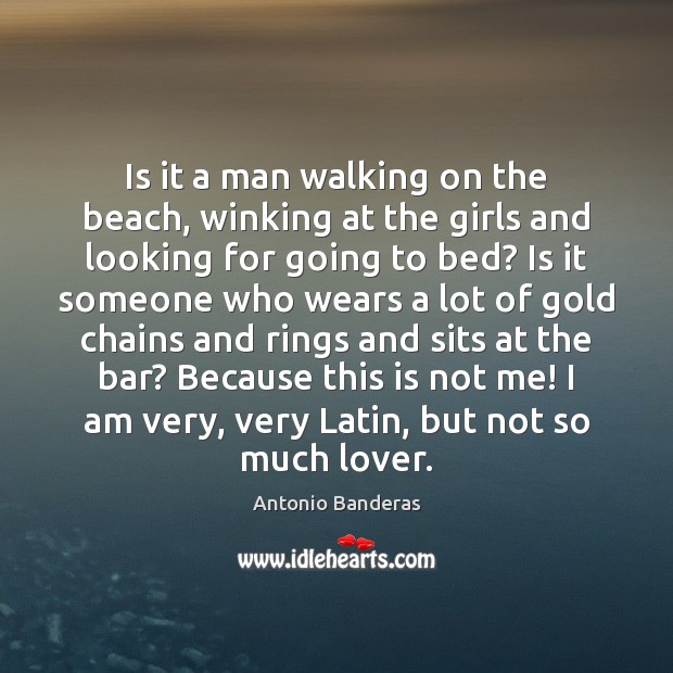 Is it a man walking on the beach, winking at the girls Image