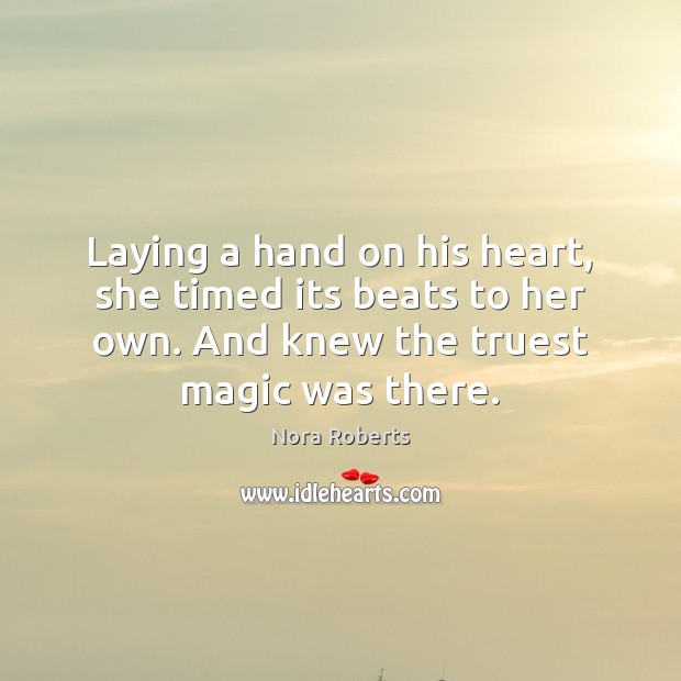 Laying a hand on his heart, she timed its beats to her Nora Roberts Picture Quote