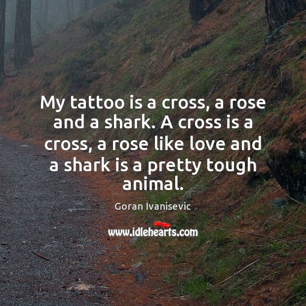 My tattoo is a cross, a rose and a shark. A cross Image