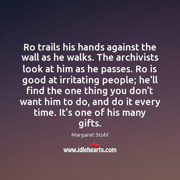 Ro trails his hands against the wall as he walks. The archivists Image
