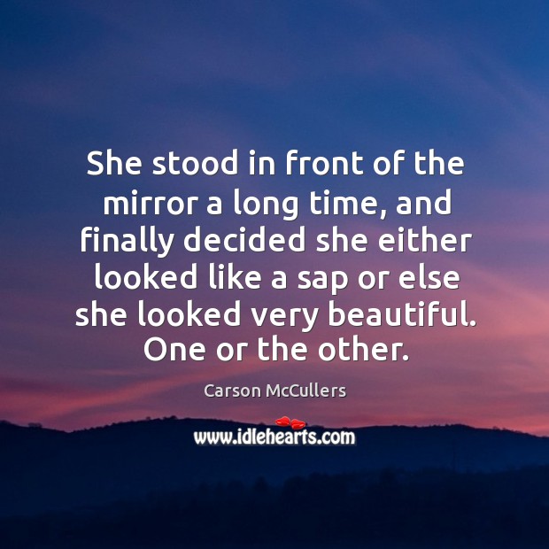 She stood in front of the mirror a long time, and finally Image