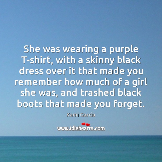 She was wearing a purple T-shirt, with a skinny black dress over Image