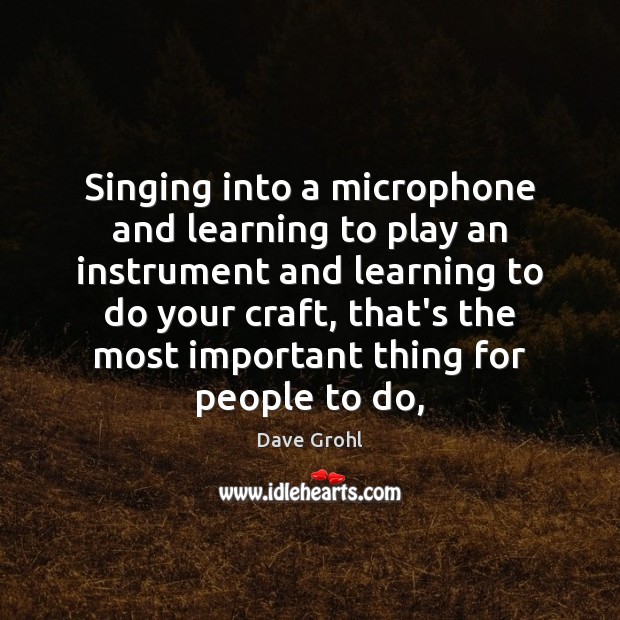 Singing into a microphone and learning to play an instrument and learning Image