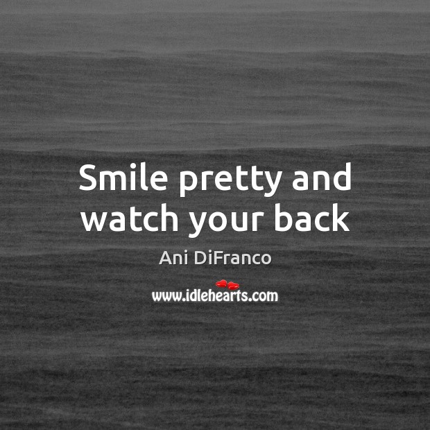 Smile pretty and watch your back Image