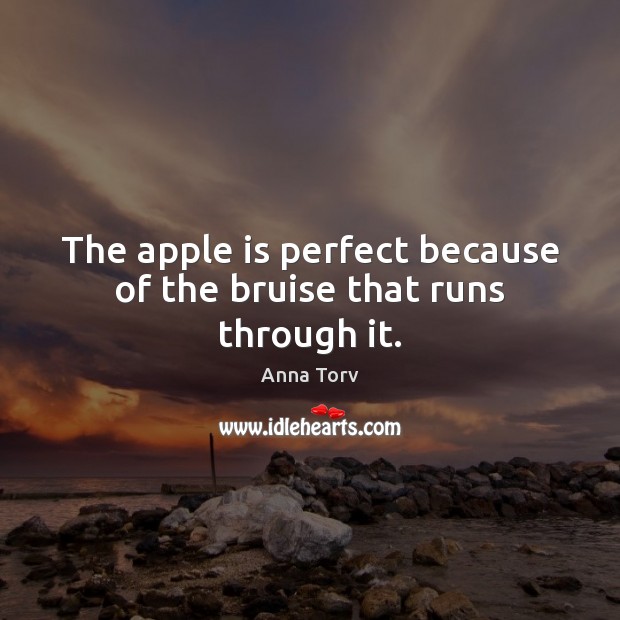 The apple is perfect because of the bruise that runs through it. Image
