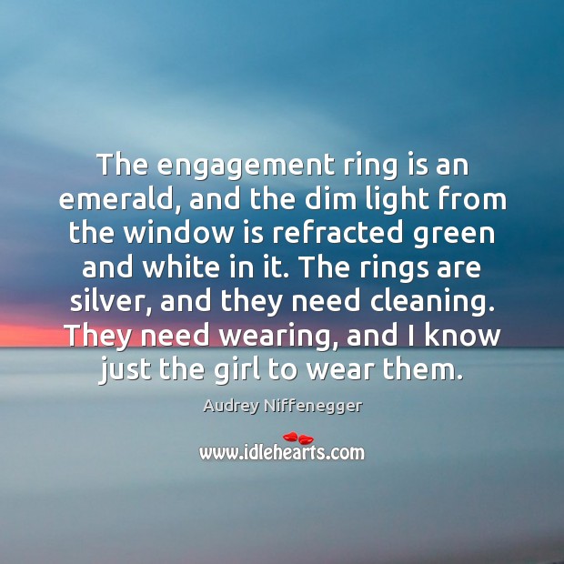 The engagement ring is an emerald, and the dim light from the Audrey Niffenegger Picture Quote