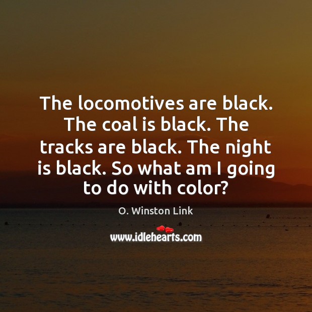 The locomotives are black. The coal is black. The tracks are black. Image