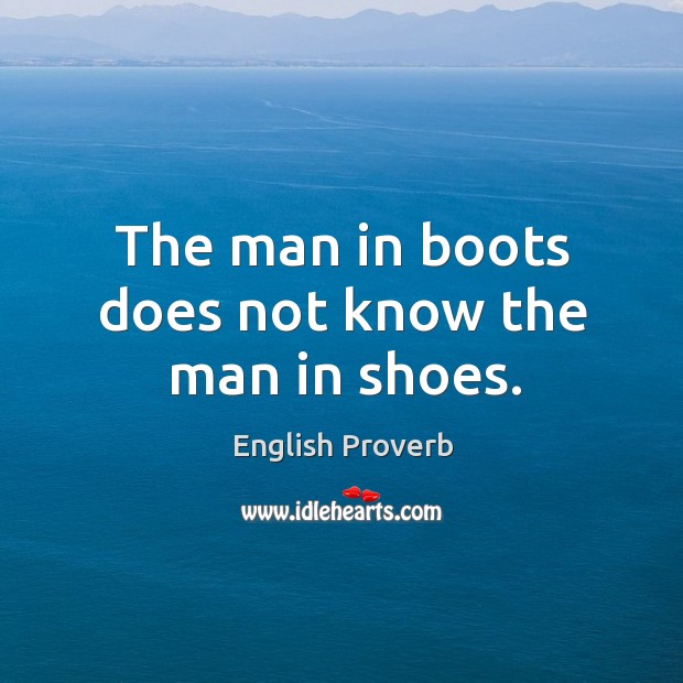The man in boots does not know the man in shoes. Image