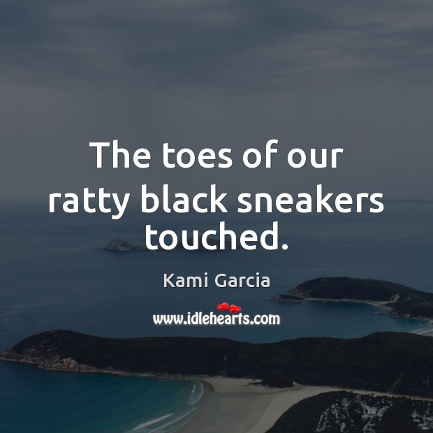The toes of our ratty black sneakers touched. Image