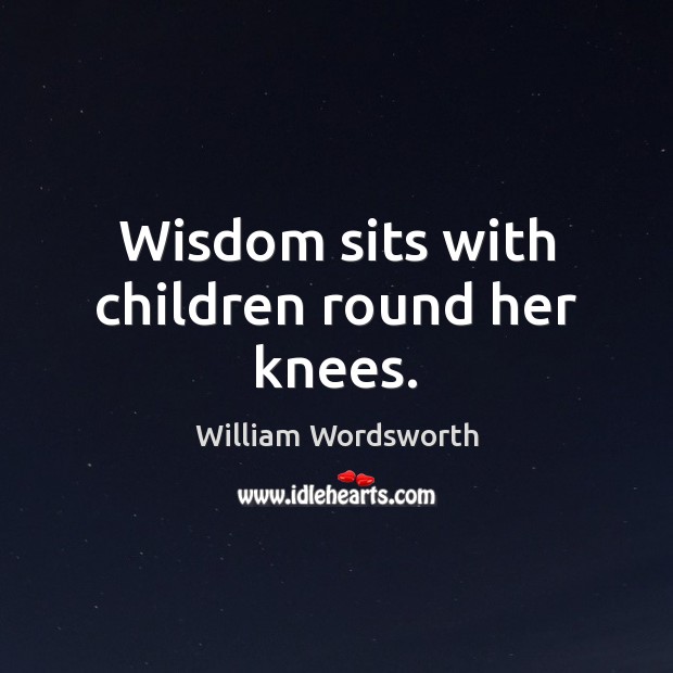 Wisdom sits with children round her knees. Image